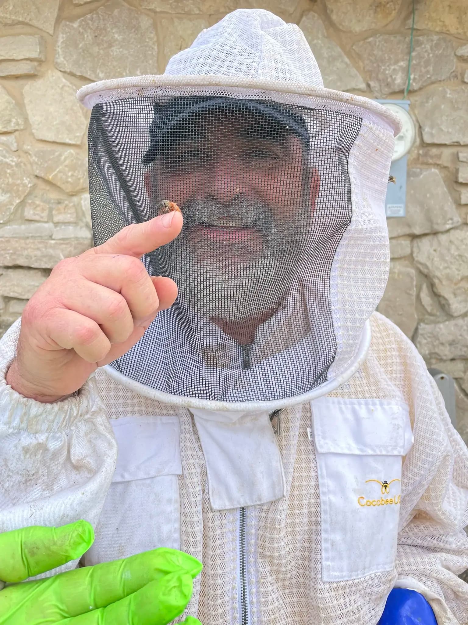 Shel in his bee suit holding a bee